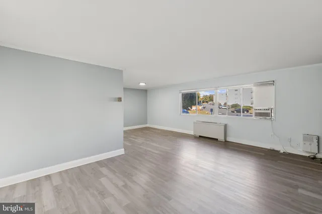 a view of a kitchen with wooden floor and windows
