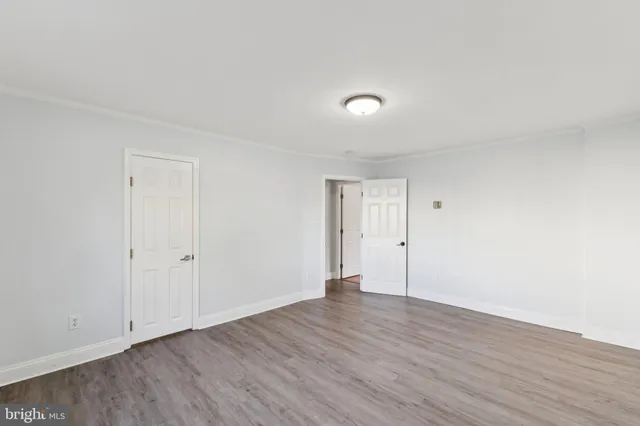 a view of an empty room and wooden floor