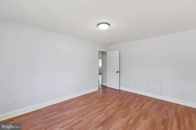 a view of an empty room and wooden floor
