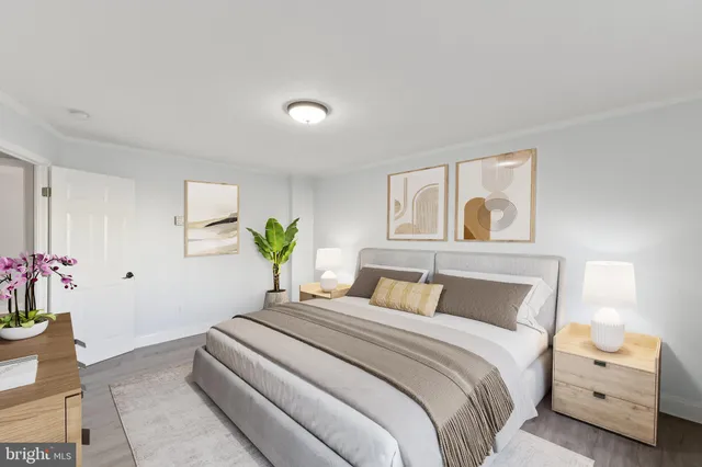 a bedroom with a bed and a painting on the wall