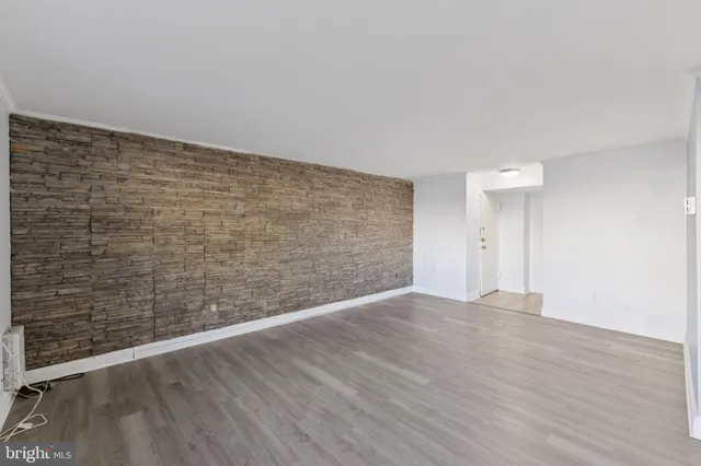 a view of an empty room and wooden floor