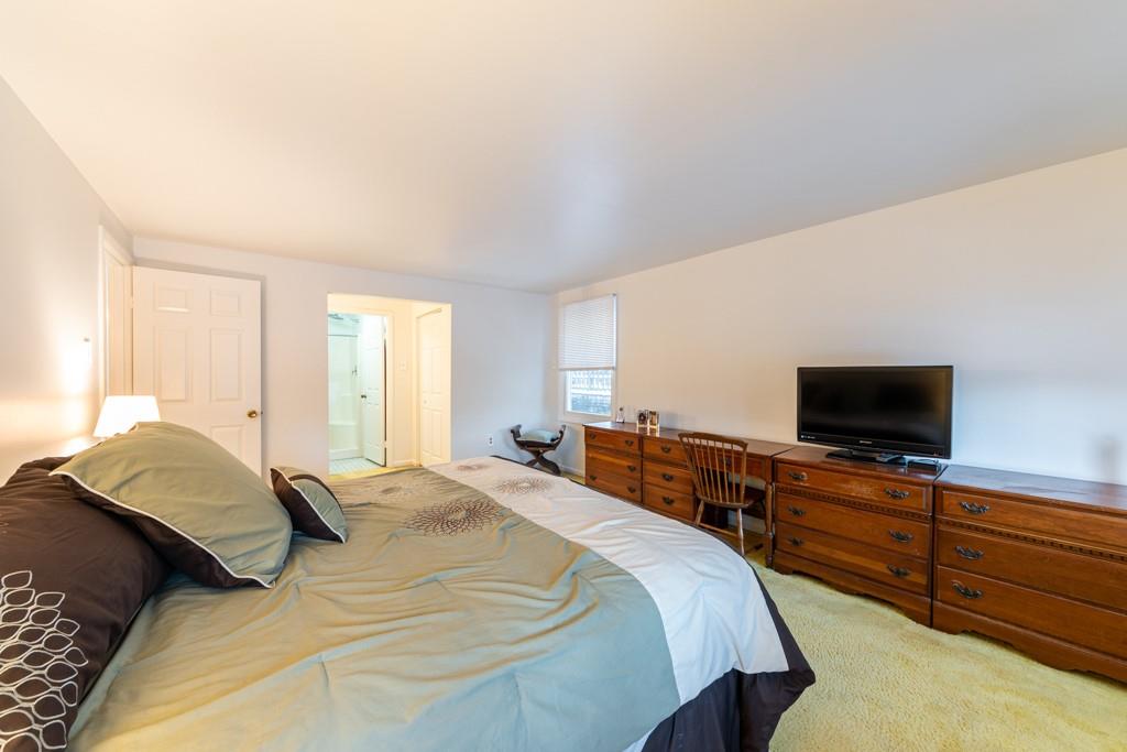 614 Ravencrest Road Pittsburgh, PA 15215 - Photo 14 of 25 a bedroom with a bed and a flat screen tv