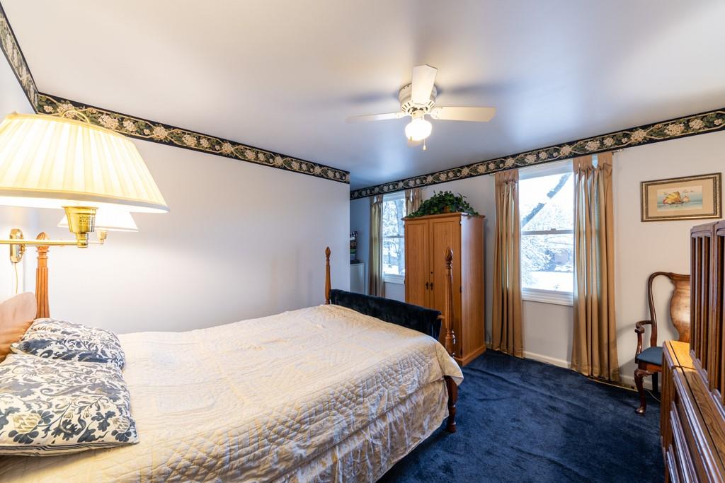 614 Ravencrest Road Pittsburgh, PA 15215 - Photo 16 of 25 a bedroom with a large bed and a chandelier