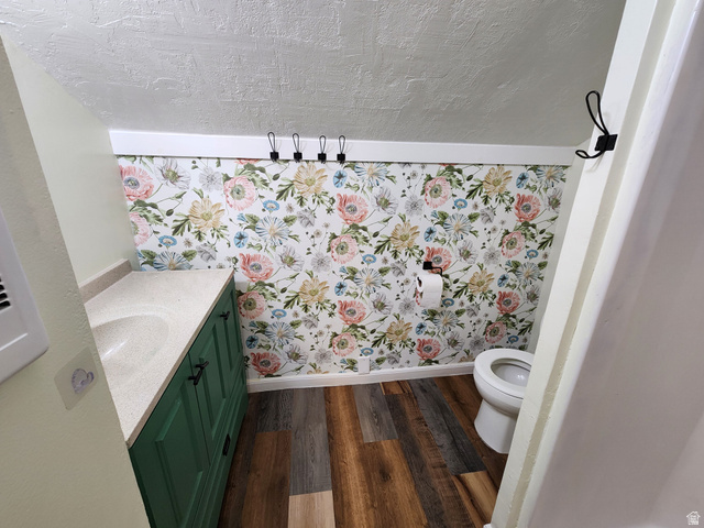 320 South State Street Preston, ID 83263 - Photo 14 of 20 Bathroom with vanity, dark wood finished floors, a textured ceiling, and wallpapered walls