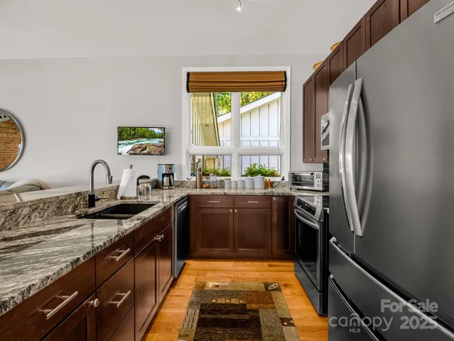 a kitchen with a sink and a clock on the wall