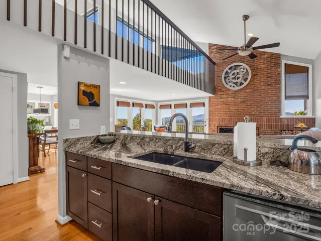 a living room with furniture a fireplace and a window