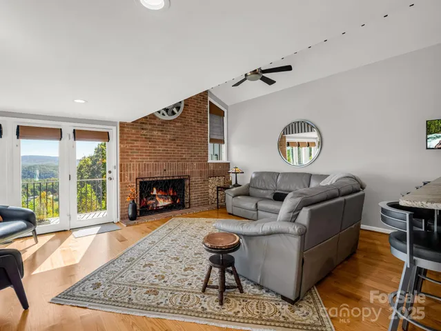 a living room with furniture wooden floor and kitchen view