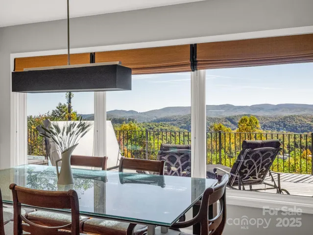 a living room with furniture and large windows