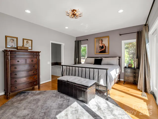 a bathroom with a tub and a view of bathroom