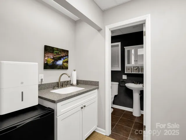 a kitchen with sink and cabinets