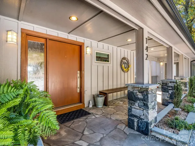 a lobby with furniture and potted plants