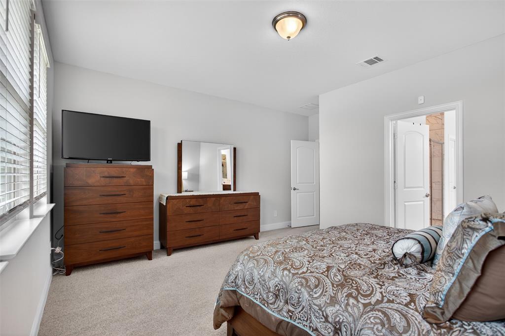 1002 Coppersmith Way Forney, TX 75126 - Photo 18 of 39 a bedroom with a bed and furniture