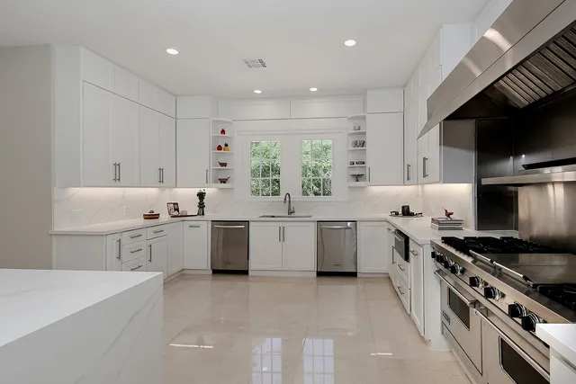 a kitchen with a sink stove top oven and cabinets