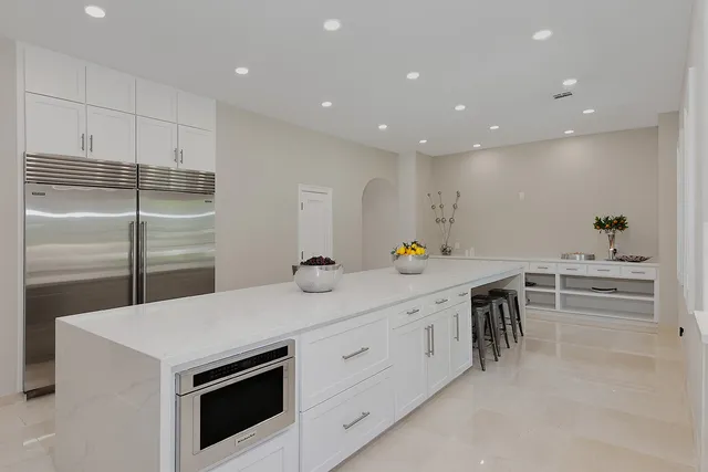 a kitchen with a sink and white cabinets