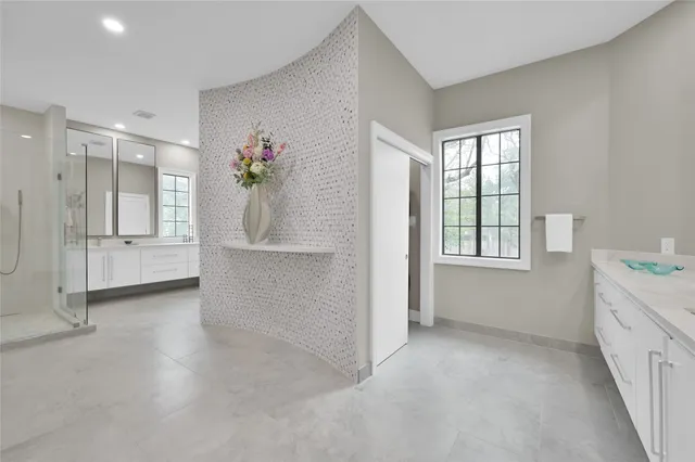 an empty room with windows and cabinet