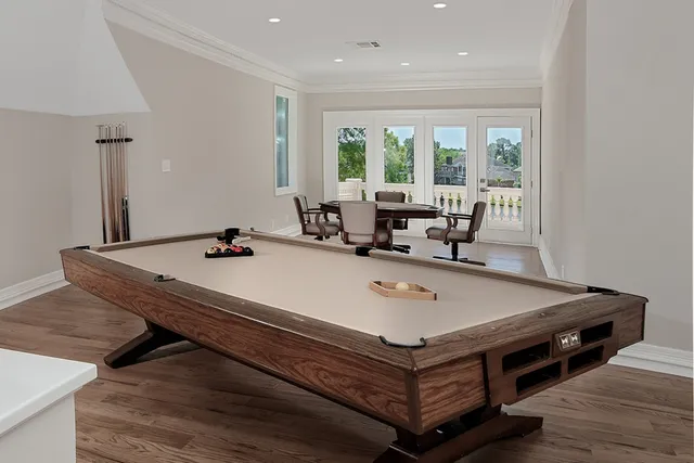 a room with pool table and windows