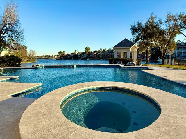 swimming pool view with a lake view