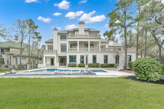 a front view of a building with street and trees