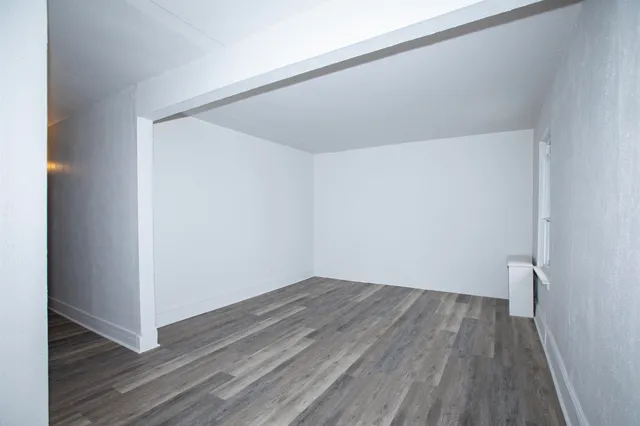 a view of hallway with wooden floor