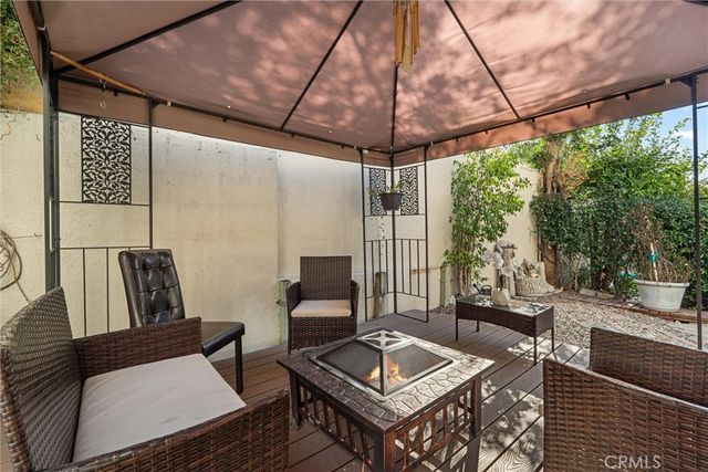 a outdoor space with the couches and dining table with the view of outdoor space