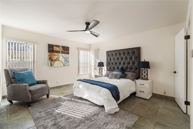 a bedroom with a bed and a couch