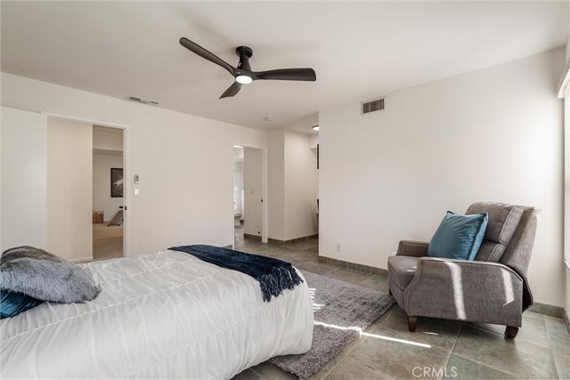 a bedroom with bed and a couch