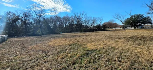 a view of dirt yard with a tree