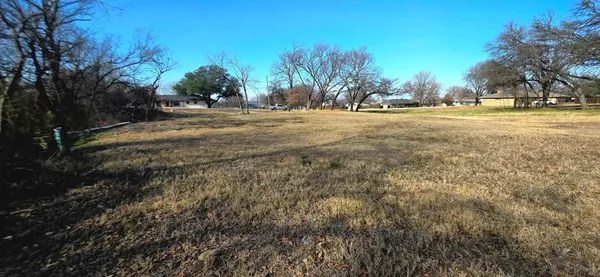 a big yard with lots of green space and trees