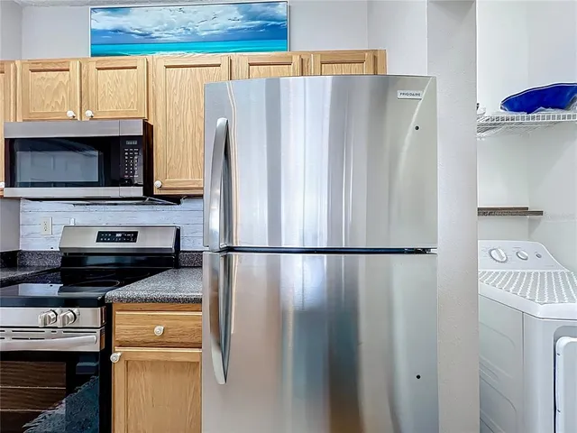 a white refrigerator freezer sitting in a kitchen