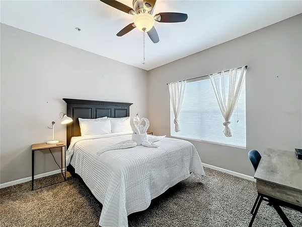 a bedroom with a bed and a chandelier