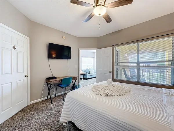 a bedroom with a bed and a flat screen tv