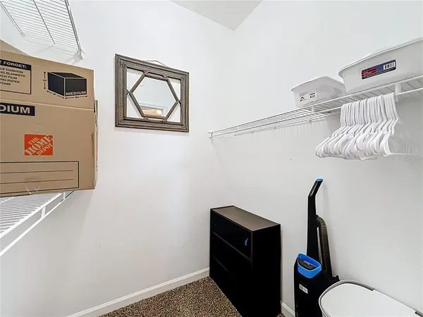 a bathroom with a toilet and a picture