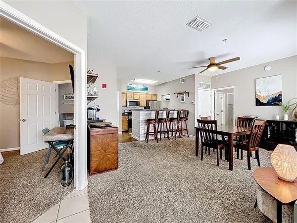 a living room with furniture a dining table and chairs