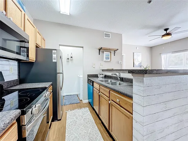 a kitchen with stainless steel appliances granite countertop a stove and a refrigerator
