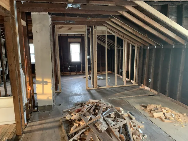 a view of a porch with a table and chairs