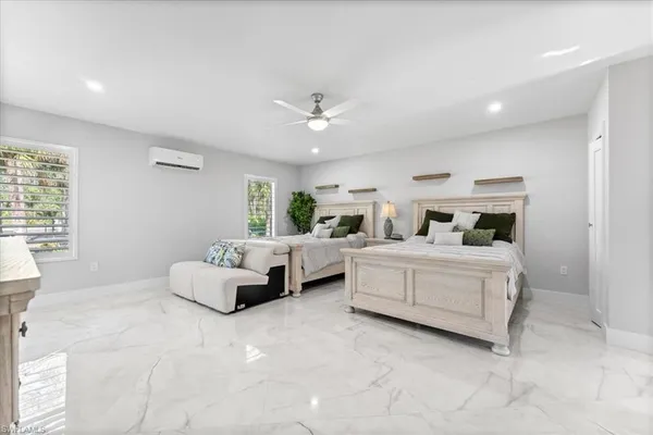 a bedroom with bed and white walls