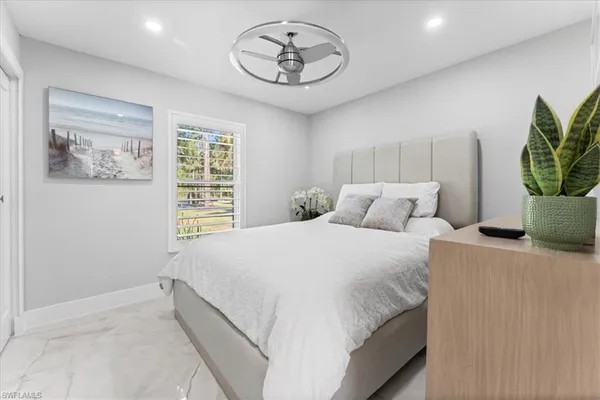 a bedroom with bed and a window