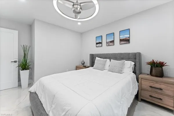 a bedroom with a bed and a chandelier