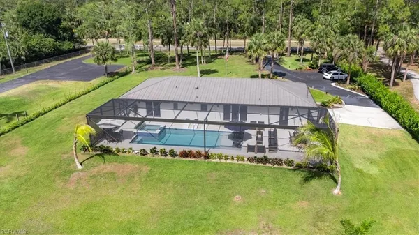 an aerial view of a house with a swimming pool