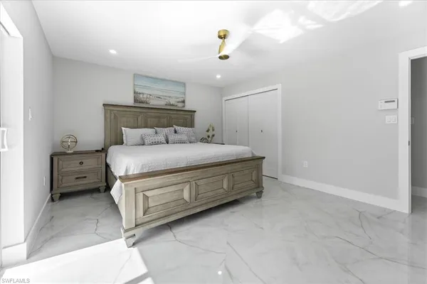a bedroom with a bed and a chandelier