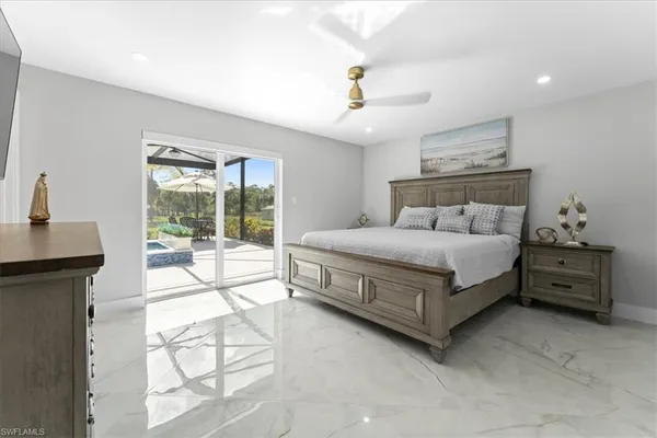 a bedroom with a bed and a large window