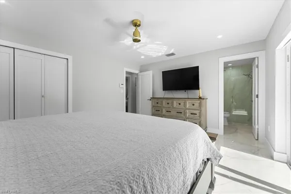 a bedroom with a bed and a flat screen tv