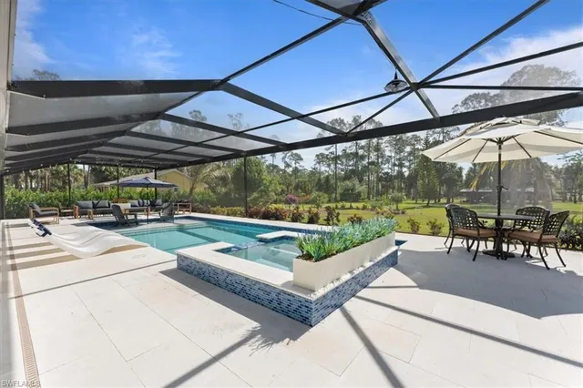 a view of a patio with a table and chairs under an umbrella
