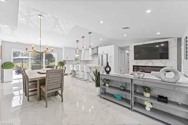 a kitchen with stainless steel appliances kitchen island granite countertop a sink and cabinets