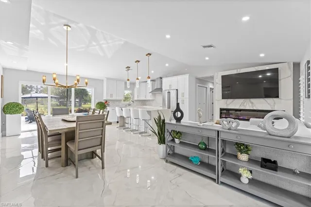 a kitchen with stainless steel appliances kitchen island granite countertop a sink and cabinets