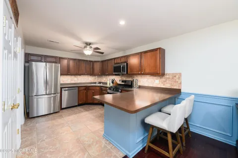 a kitchen with kitchen island a sink table and chairs