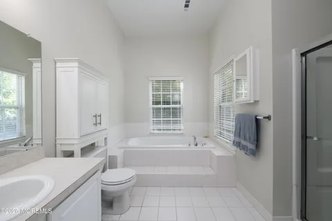a bathroom with a granite countertop toilet a sink and bathtub