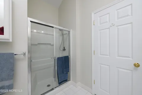 a bathroom with a shower and a glass door