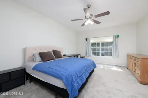 a spacious bedroom with a bed and window