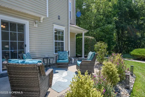 a view of a house with backyard sitting area and garden